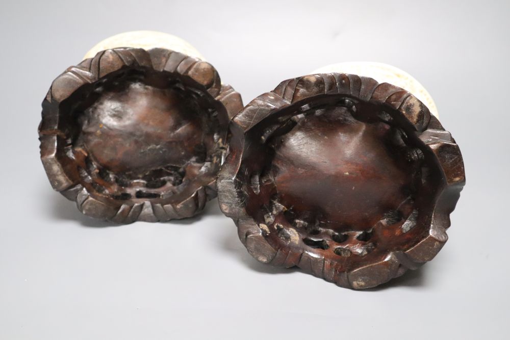 A pair of early 20th century Chinese ivory pots, with carved wood stands, overall height 16cm